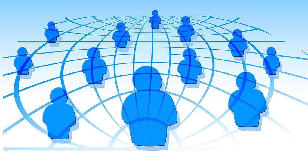 Cartoon representation of people forming network on globe grid
